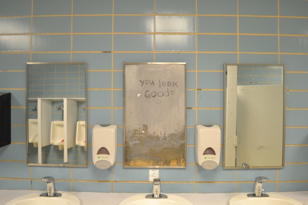 LOOKING GOOD -- Graffiti artists and possible humorists left a positive message scrawled in the mens restroom where a broken mirror stands.