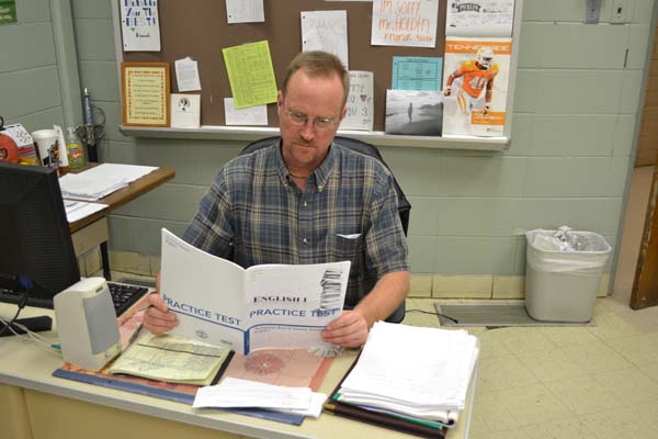 HOLDIN' ON -- English 9 teacher Mr. Mark Holden reviews EOC practice tests prior to his fifth-block class.