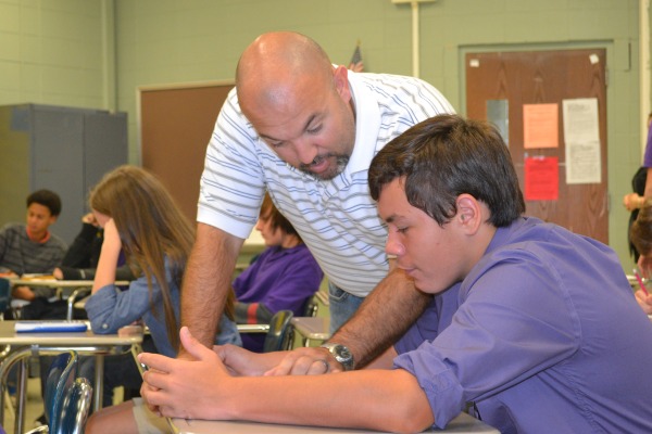 HARD AT WORK -- Mr. Plemons aids freshman Jake Biddy with an Algebra I assignment.