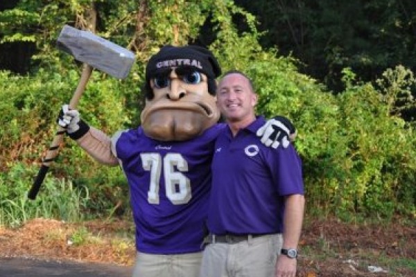 PURPLE POUNDER PRIDE -- Stan The Pounder Man and Principal Finley King enjoy a football game.