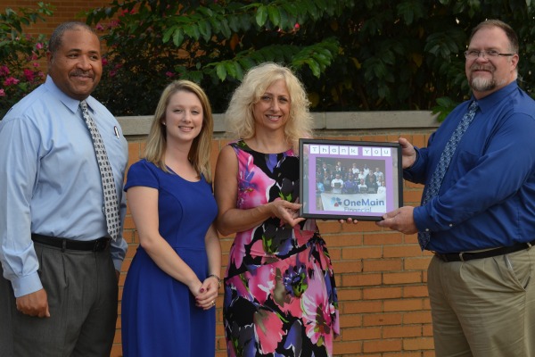 BRIELLE FARROW PICKED AS THE CLASS OF 2021 DEDICATORY -- (From left to right) Biology teaher Gary Fomby, instructional coach Brielle Farrow, OneMain Financial branch manager Betsy Corum, and Assistant Principal Steve Lewis celebrating a grant that was awarded to assist Farrow's chemistry classes. File photo from 2014.