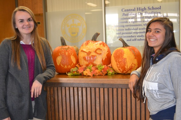 PUMPKIN CARVING TRADITION -- Caitlin Maupin and Kelly Wnuk show off their detailed pumpkin carvings along with Mr. Rob's (center).