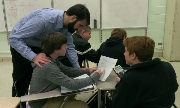 NEW ALGEBRA TEACHER -- Mr. Steward helps his students (from left to right) Hayden Gracy, Dakota Gable, Davey Vagts, and Andrew Bingham with their Algebra I homework.