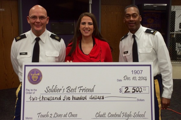 A CHECK LARGER THAN LIFE -- Ms. Thomas presented this check to her psychology students with (from left to right) Sergeant Major David Lewis and Lieutenant Colonel Bill Brooks.