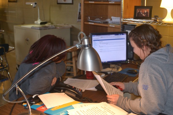 STAFF MEMBERS ON DECK -- Bria Battle, left, and Shai Markum, right,  work on more upcoming changes for the 2015-2015 yearbook.