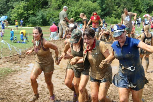 MUD RUN -- Mrs. White (far left) trucks through the muck-covered obstacle courses of
the Mud Run with her friends.