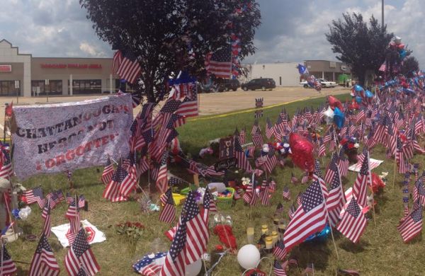 CHATTANOOGA MEMORIAL ON LEE HIGHWAY HONORS FALLEN SERVICEMEN -- Thousands of flags, banners, and flowers sit in front of the Armed Forces Career at a town-made memorial for the five fallen servicemen.