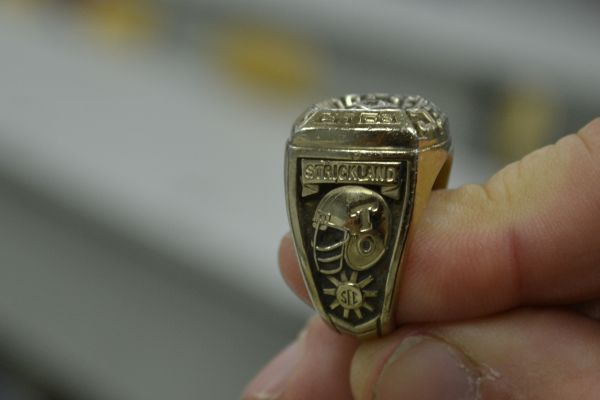 FORMER CHAMPIONS ROAM THE HALLS OF CENTRAL HIGH -- 9th grade physics teacher Chip Strickland proudly shows off his 1985 Sugar Bowl Championship ring.