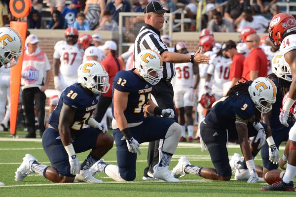 TIMOSHCHUK PREPARES FOR THE PLAY -- (Left to right) Dale Warren, Nikolay Timoshchuk, and Alphonso Stewart are getting into their stances at the Jacksonville State University earlier this season.