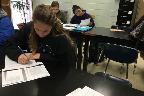 FORENSICS FUN -- Senior Katy Pollock enjoys reading the case studies Mrs. Cotreau assigns in class.