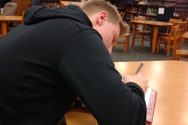 STUDENTS GET INTO THE GROOVE OF WRITING FOR BLACK HISTORY MONTH -- Junior Taylor Hamby gets his creative juices flowing. 