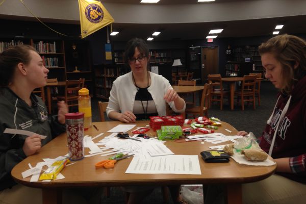 STUDENTS HONOR HARPER LEE WITH SILENT ACTS OF KINDNESS --- (left to right) Cheyenne Slaughter, Ms. Sally White, and Hannah Stone prepare the items they are handing out. 