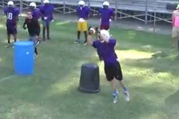 FOOTBALL CONDITIONING BEGINS -- Evan McDaniel, an upcoming sophomore, catches the ball during a drill. 