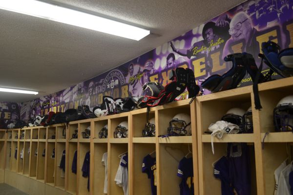 LOCKER ROOMS GET A NEW UPGRADE -- Coach Braswell and other member of the football team get together and redecorate the locker rooms.
