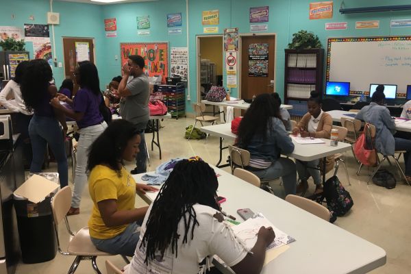 FOUNDATIONS OF DESIGN AND FASHION CLASS AT WORK-- The students of the foundation class work together to design posters.