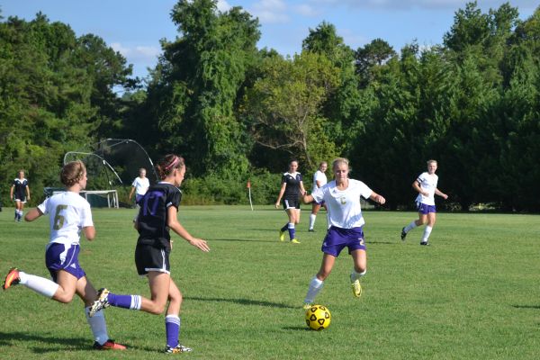 LADY POUNDERS BRING HOME THEIR FIRST VICTORY-- Celisia Snakenberg (center) runs after the soccer ball to secure Centrals possession. 