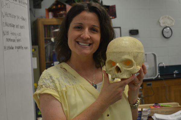 CHRISTINA COTREAU SHOWS OFF HER LOVE FOR BIOLOGY -- Mrs. Cotreau holds on tight to her fake skull while she teaches students about the human body.