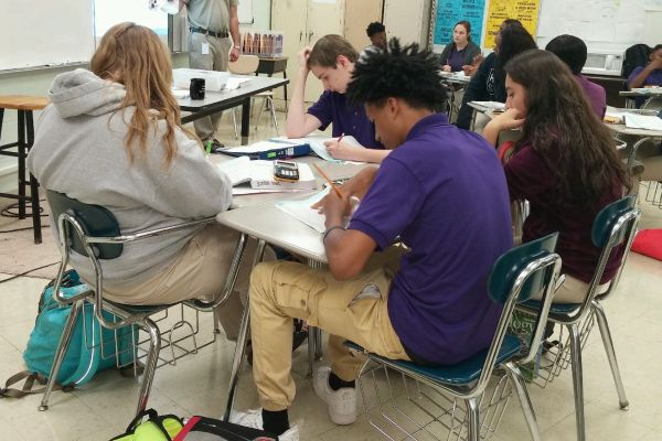 STUDENTS IN DAY-TO-DAY DRESS CODE -- Students in Mr. Mullins  room do their work while sporting their favorite dress code items