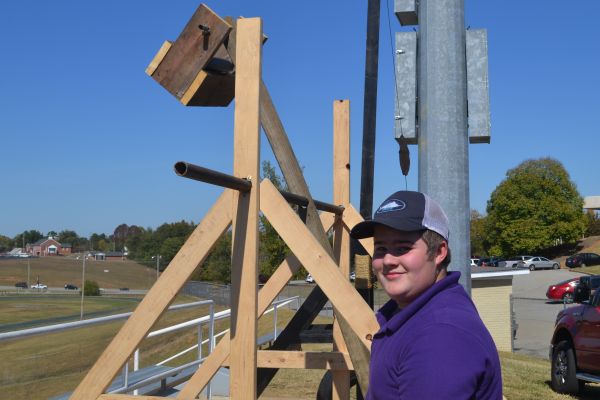 AIM & FIRE -- Freshman Colt Davidson stand tall by his catapult in the Giant Category.