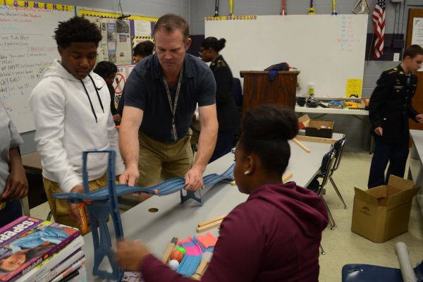 RUBE GOLDBERG MACHINE -- The students work in groups to build different parts of a Rube Goldberg machine.