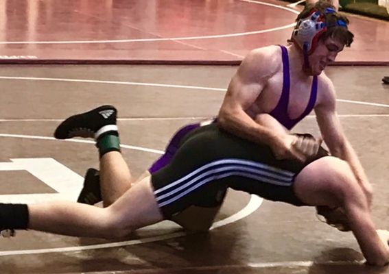 HARD WORK CONTINUES TO PAY OFF FOR WRESTLER ISAAC COFFEMAN--  Isaac Coffman pins down his opponent in a wrestling match 