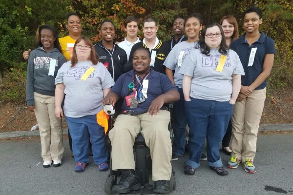 CENTRAL CDC TEACHER GETS SELECTED AS GOLDEN APPLE TEACHER OF THE WEEK -- Teacher Romonda Word (far back row in the yellow shirt) and her students cheerfully pose outside the school. 