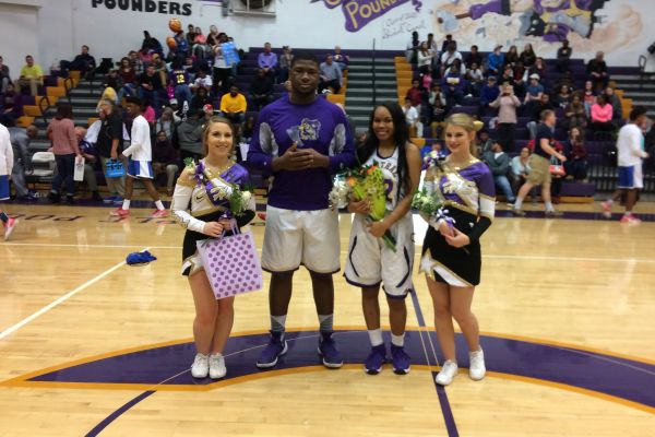 GIRLS AND BOYS BASKETBALL TEAM CELEBRATES SENIOR NIGHT AFTER BIG WIN -- Senior cheerleaders (from left to right) Vanessa Smith and Miranda Lillard celebrate their Senior Night with senior boys basketball player McClendon Curtis and senior girls basketball player Miracle Miller.