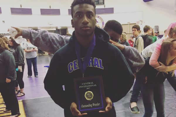 ATHLETE SPOTLIGHT: ALONZO HEYWARD STARTS TO LOOK BACK ON HIGH SCHOOL WRESTLING MEMORIES-- Heyward poses after match with his Outstanding Wrestler Award.