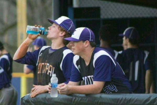 HARD WORK PAYS OFF-- Andrew Bingham (left) and Walker Waters (right) cool off in the dug out.