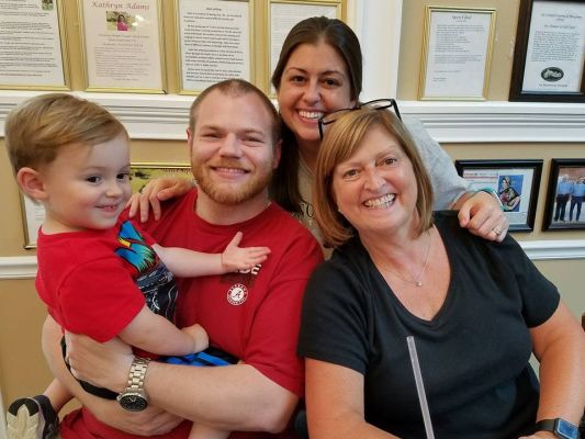 MRS. MOORE LOVES SPENDING TIME WITH HER FAMILY -- Mrs. Moore (far right) spends some quality time with her grandson, Wyatt Hawkins (far left), her son-in-law, Jason Hawkins (center left), and her daughter, Paige Hawkins (center right).