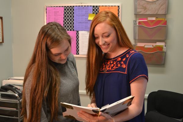 CENTRAL WELCOMES MS. HENSLEY -- (Left to right) Senior Michelle Caszatt and Shea Hensley discuss schedules.