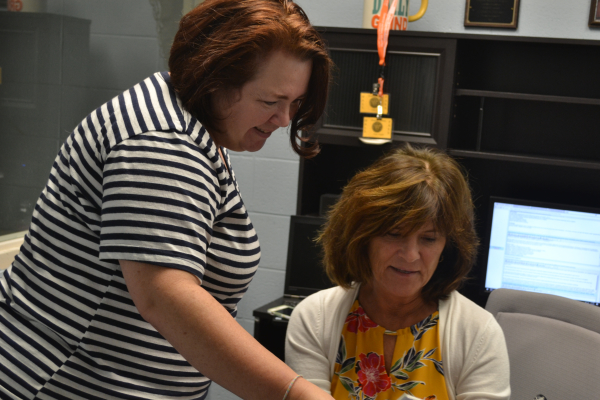 TEACHER SPOTLIGHT: ELISABETH ZACHARY WELCOMED AS OUR NEW CURRICULUM COACH -- Ms. Hooper (left) goes over lesson plans with Ms. Zachary (right).