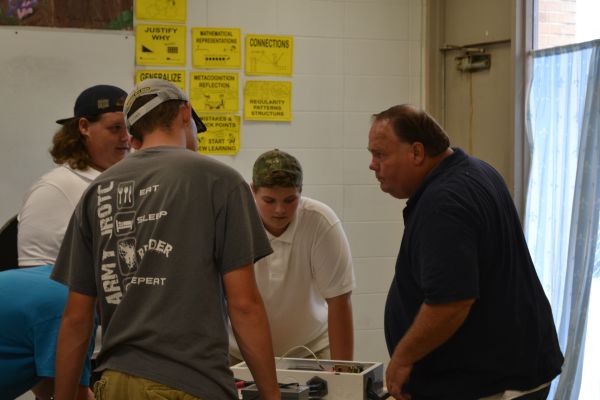 TEACHER SPOTLIGHT: CENTRAL HIGH WELCOMES NEW MECHANICS AND CONSTRUCTION TEACHER MR. WEBB -- Mr. Webb helps a group of his students work on their first project of the year 