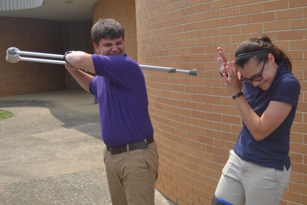 SENIOR VS. FRESHMAN --  Freshman Alex White pretends to beat up injured senior Haylee Smith.