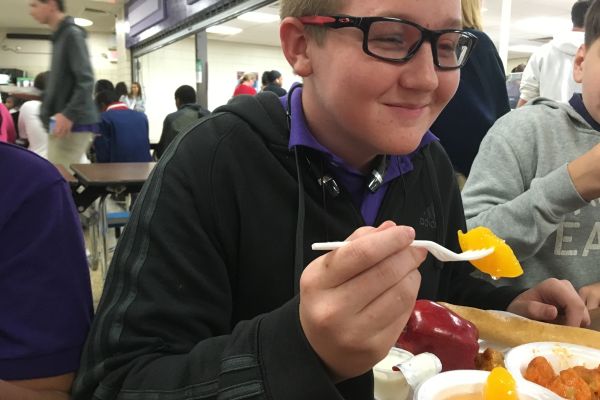 STUDENTS' OPINIONS ON SCHOOL LUNCHES: COULD IT BE BETTER? --Freshman Jeremy Rogers is enjoying his peachy lunch provided by the Central High School Cafeteria Staff.