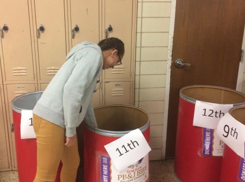 CENTRAL HIGH COLLECTS WINS PEANUT BUTTER AND JELLY BOWL -- Junior Alexis Massengale donates her jar of peanut butter to help out those affected by Hurricane Harvey.