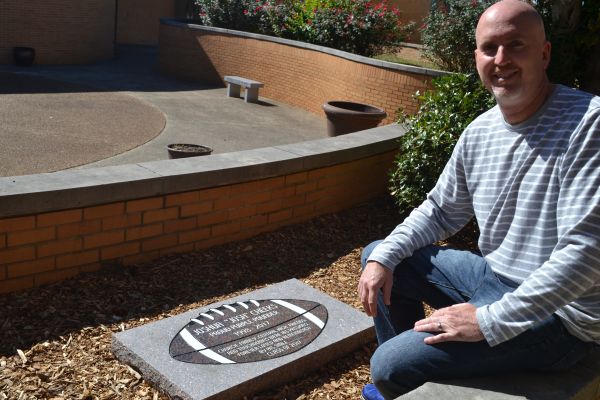 RICK ROGERS NAMED EDUCATOR OF THE WEEK  -- Mr. Rogers next to the memorial for Josh Cheeks, one of his previous students. 
