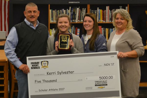 KERRI SYLVESTER EARNS SCHOLARSHIP FOR HARD WORK -- Kerri Sylvester poses with her family and $5000 scholarship check