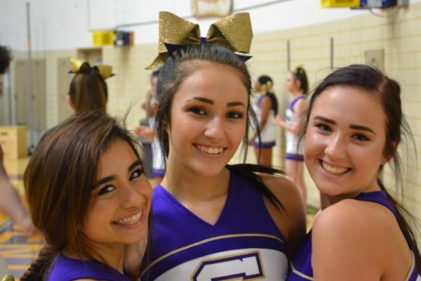 LETS GO POUNDERS -- (left to right) Cheerleaders Anahi Colunga, Maggie Watts, and Meghan Duncan prepare for the match against the Pioneers.