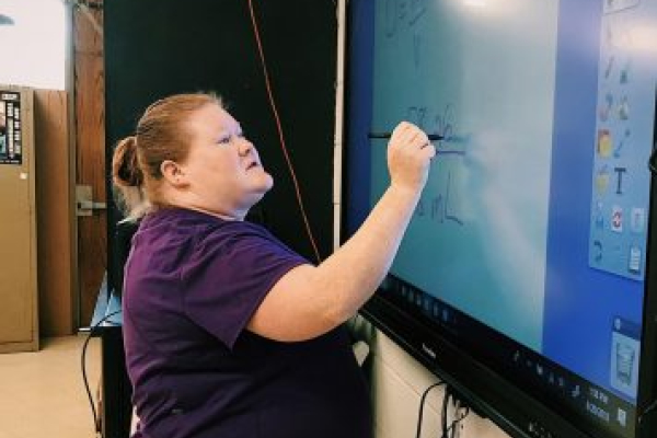  CHEMISTRY TEACHER MEGAN SANFORD MAKING A SPEEDY RECOVERY -- Mrs. Sanford is depicted working out a density problem on the Promethean board when she still taught at Central.