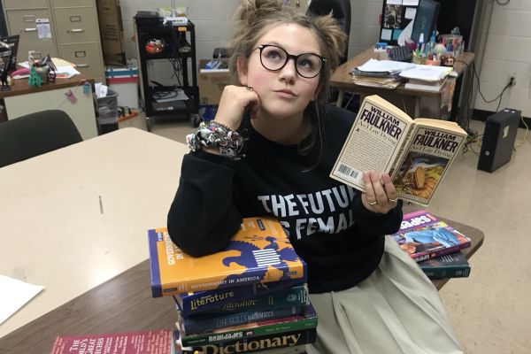 THE BEGINNING OF THE END -- Columnist Laurelie Holmberg poses with some of her favorite books.