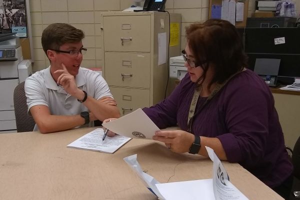 HOOPER ASSISTS STUDENT IN REVIEWING APPLICATION -- Mrs. Danielle Hooper (right) assists Junior, Grant Scutt (left), in reviewing application requirements for Governors School.