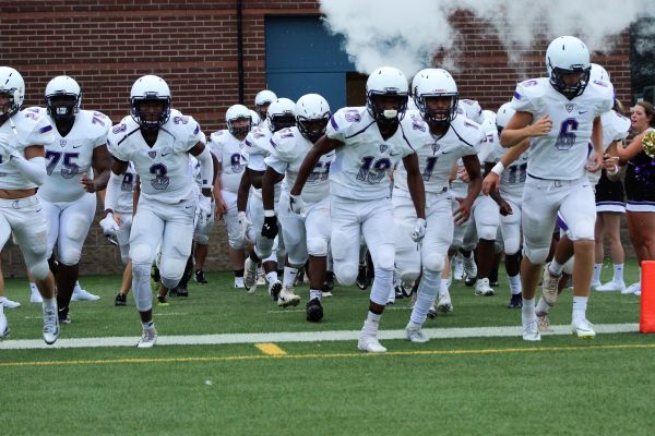 THE POUNDERS TAKE ANOTHER WIN -- The Central High football team pump up the crowd as they run onto the field.