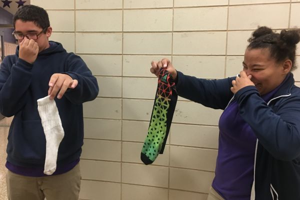 HEY STUDENTS, LET'S DISCUSS CENTRAL HIGH-GENE -- Josh Thomas and Abby Parks express visible disgusts as they hold rancid socks.