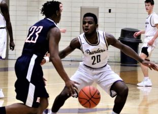 THE BOYS BASKETBALL TEAM INTRODUCES BRAND NEW LINE UP IN HOPES OF SUCCESSFUL YEAR-- Senior small forward, Darick Isom, brings the heat from last season for future victories.