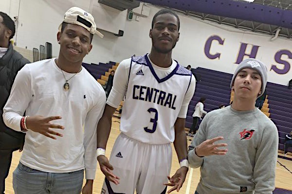SENIOR CHEERLEADERS AND BOYS BASKETBALL PLAYERS ANTICIPATE LIFE AFTER CENTRAL -- Senior Davon Reid poses with Central fans after the boys basketball victory over Hixson.