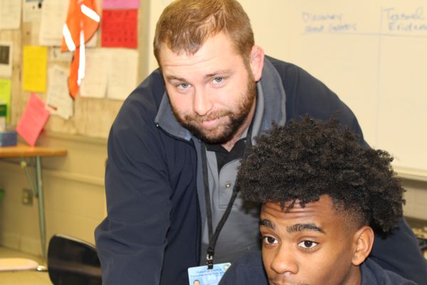 MR  WINESBURGH HELPS A HARD-WORKING STUDENT -- Ulric Winesburgh helps one of his students while working on the computer.