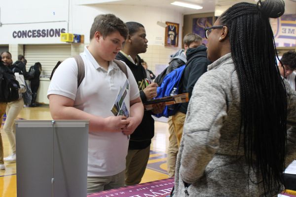 2019 CENTRAL HIGH SCHOOL COLLEGE FAIR-- A college adviser discloses details to a student.