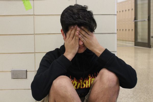 HOW IS TESTING AFFECTING OUR STUDENTS? -- Dimas Azuca, pictured above, stressing in the hallway during testing season.