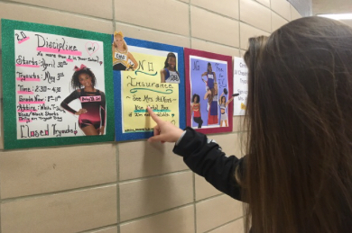 JUNIOR VARSITY CHEERLEADING TO  BE AVAILABLE AT CENTRAL NEXT SCHOOL YEAR -- Freshman Ashlyn Wood has taken interest in the junior varsity  cheerleading posters hung in the hallway. 